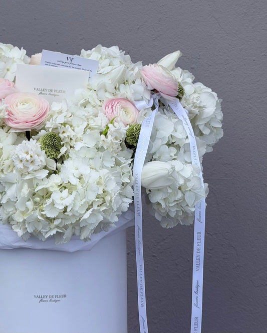 Birthday bouquet filled with White hydrangeas with blush ranunculus and tulips with happy birthday wish cards