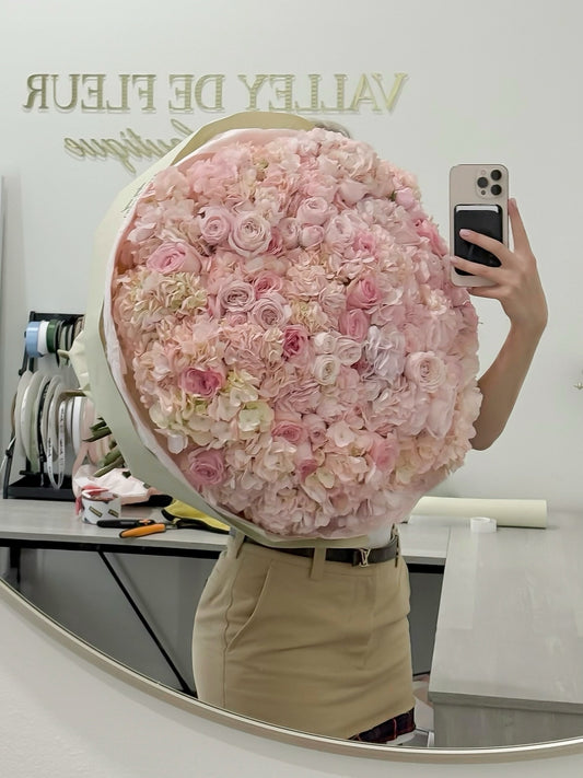 Pink hydrangeas arranged with elegant garden roses in a bouquet