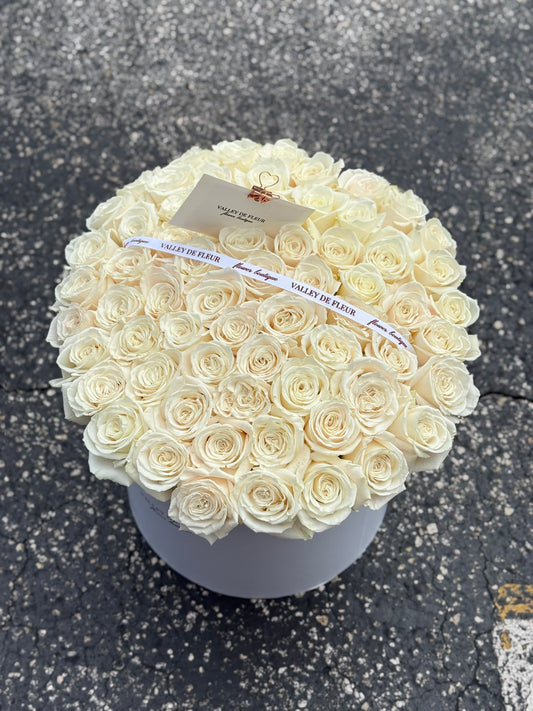 Bouquet of 50 elegant white roses arranged for a special occasion.