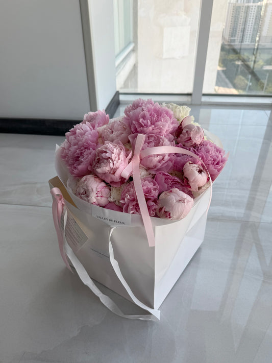 Sarah Bernhardt peonies and hydrangeas bouquet arranged with soft pink and white flowers