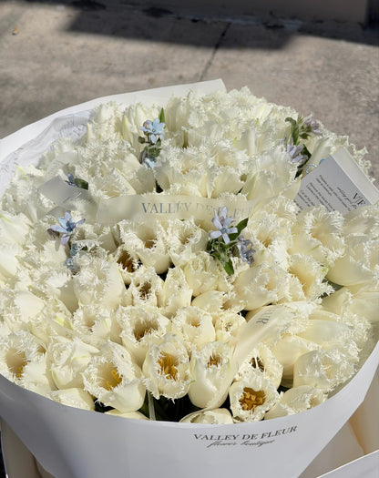 White ruffled tulips birthday bouquet ready for flower delivery with happy birthday wish card