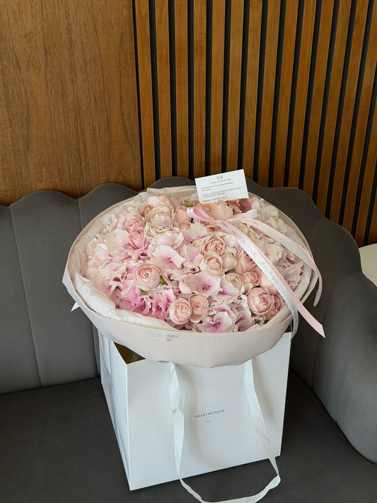Light pink hydrangeas and Fairy Kiss spray roses in a soft birthday bouquet
