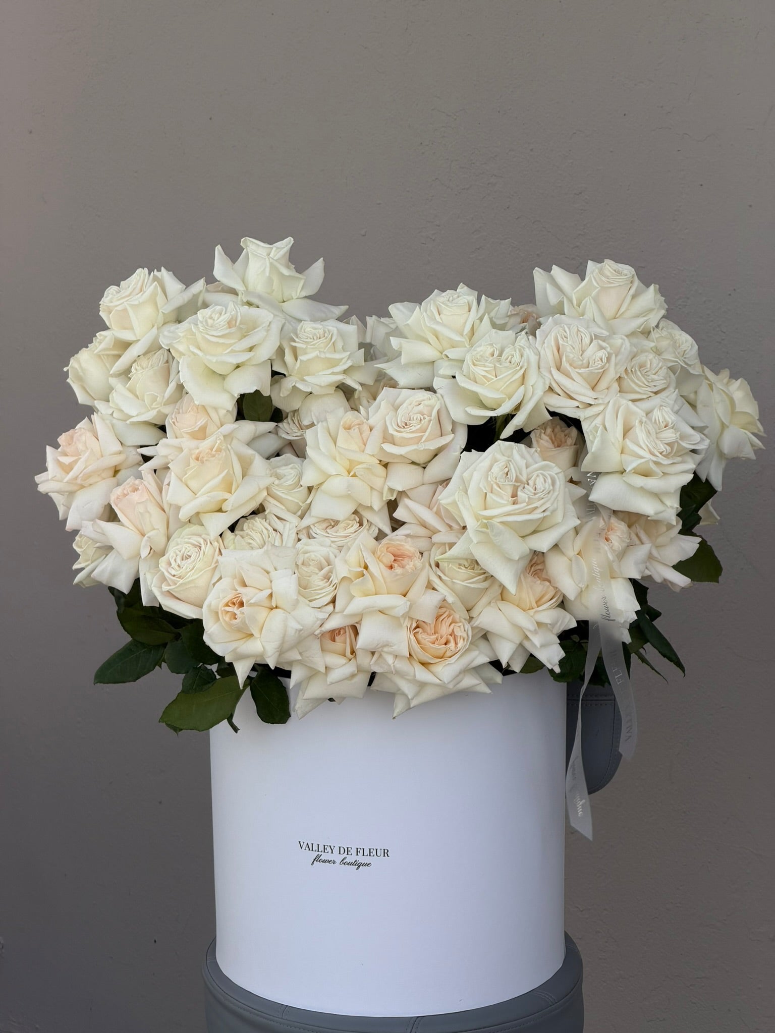 French White O'Hara roses in a full white birthday flower arrangement