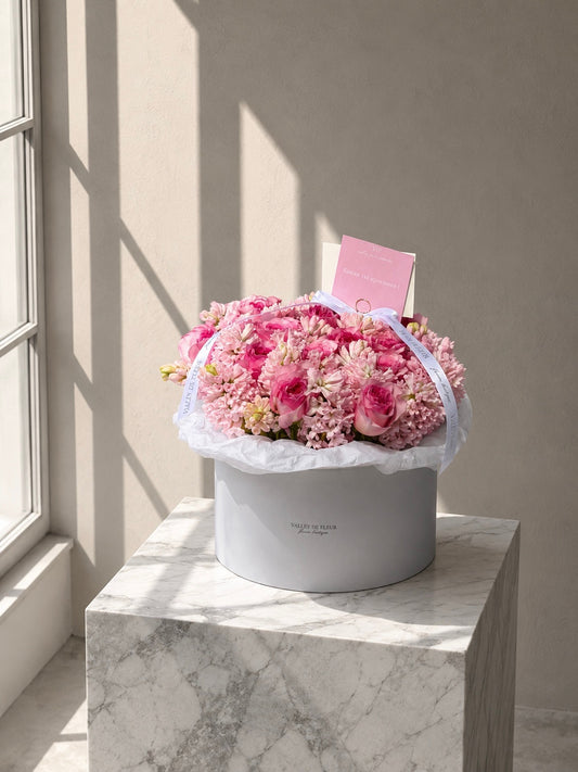 Pink garden roses and hyacinth in a round birthday flower arrangement