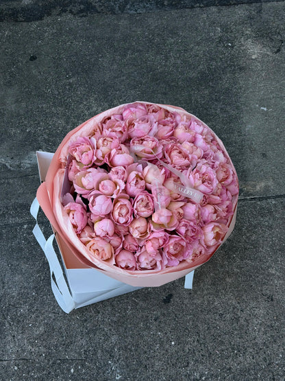 Lush light pink spray roses arranged as elegant anniversary flowers