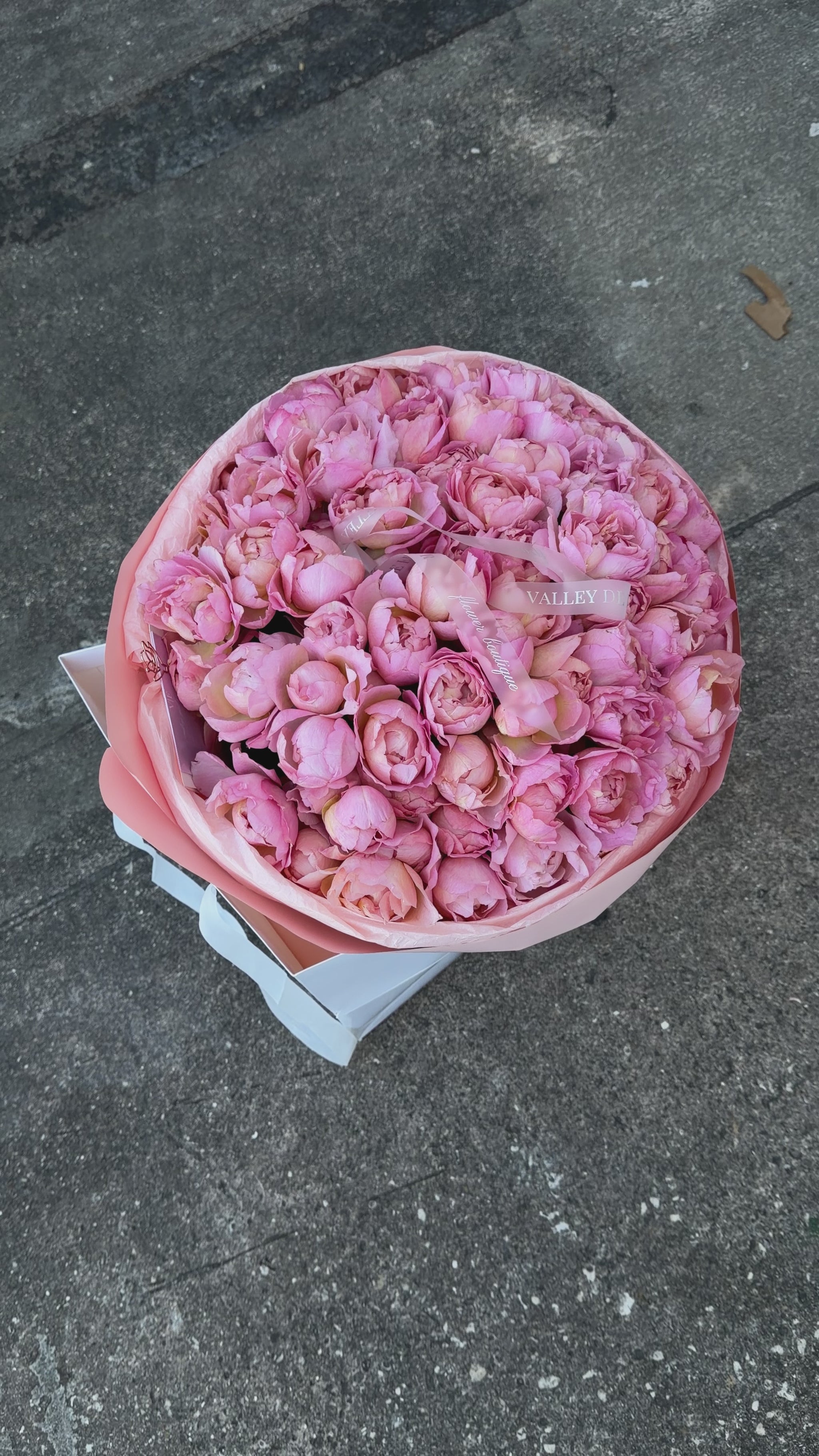 Abundant light pink spray roses with petite clustered blooms arranged in a luxurious romantic anniversary bouquet