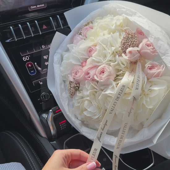 Ivory Promise bouquet featuring lush white hydrangeas and soft blush roses arranged as elegant anniversary flowers