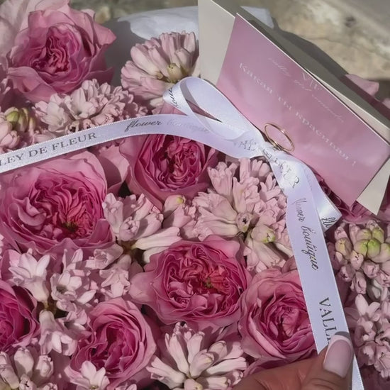 Birthday flowers featuring pink garden roses and hyacinth in a signature round flower box