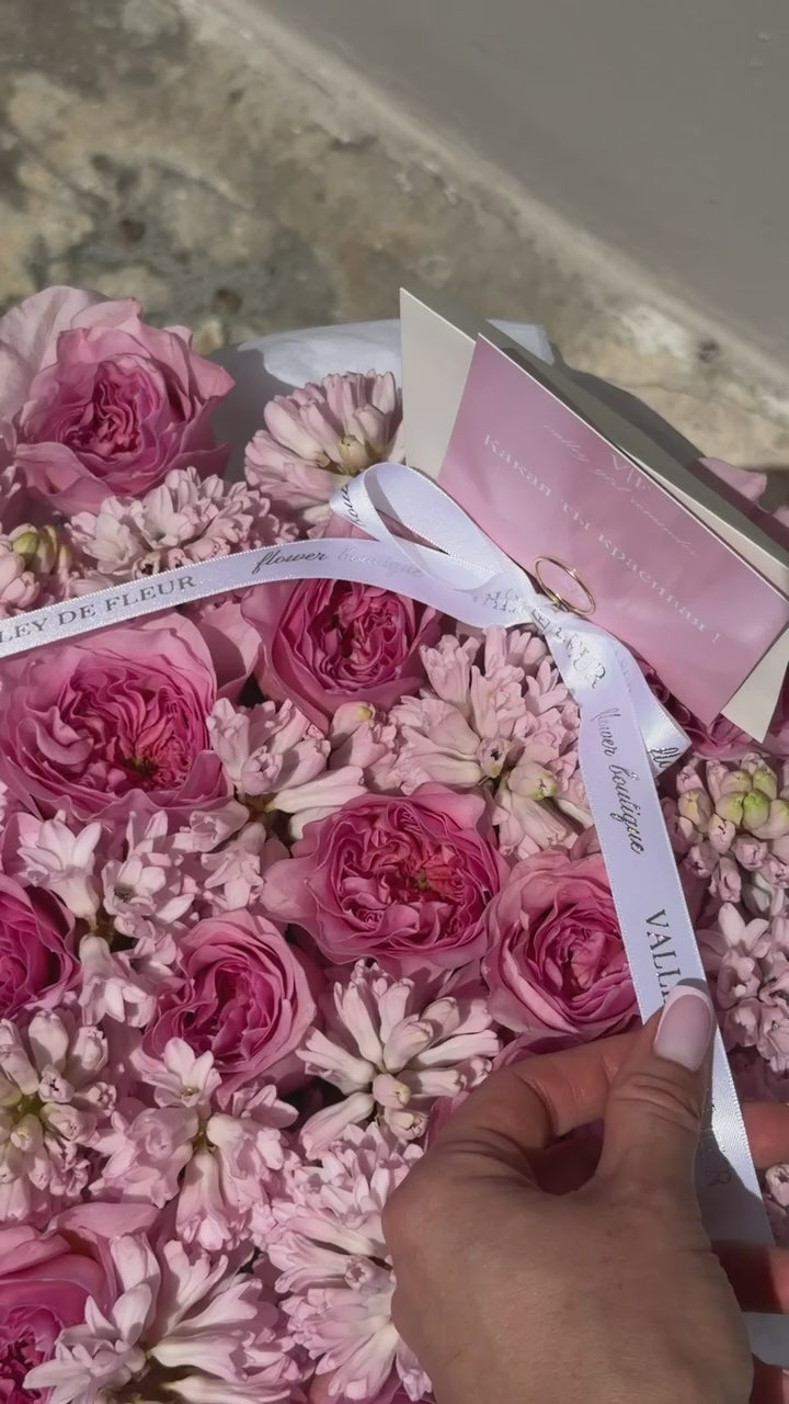 Birthday flowers featuring pink garden roses and hyacinth in a signature round flower box