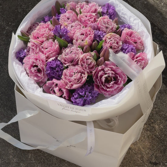 Romantic light pink tulips arranged in a luxury anniversary flower bouquet