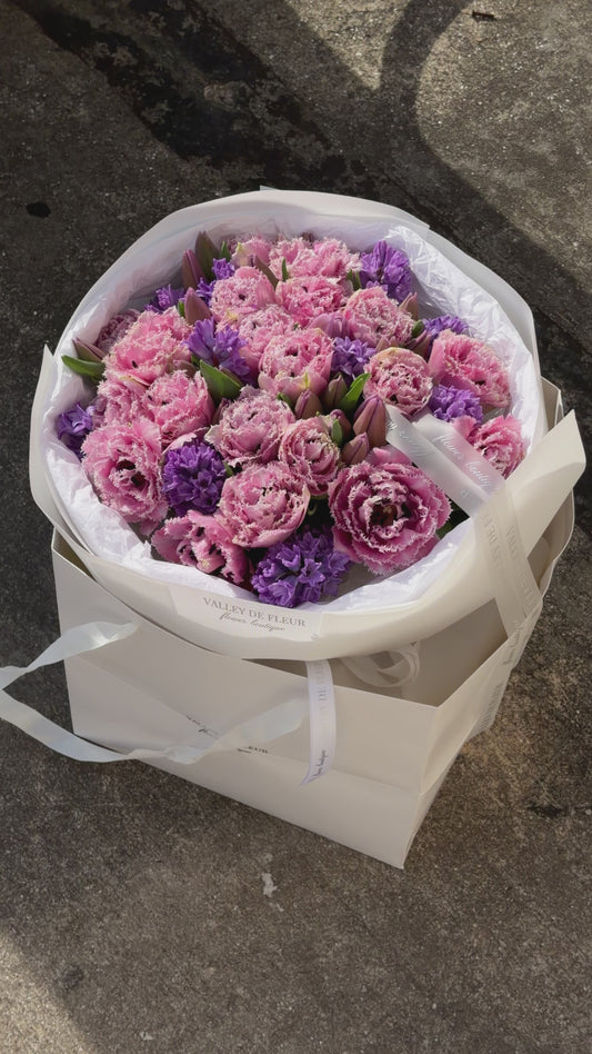 Romantic light pink tulips arranged in a luxury anniversary flower bouquet