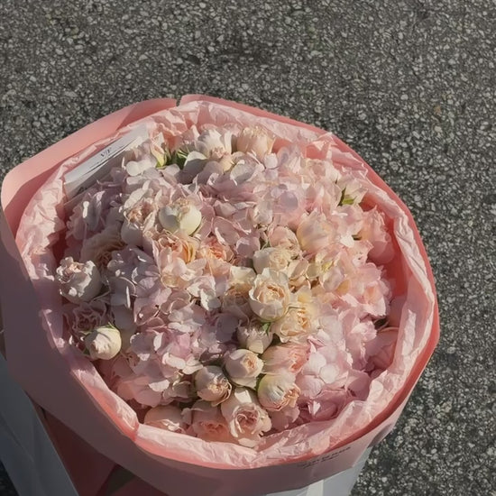 Spray roses and light pink hydrangeas in a blush birthday arrangement, ready for flower delivery across Miami-Dade and Broward County