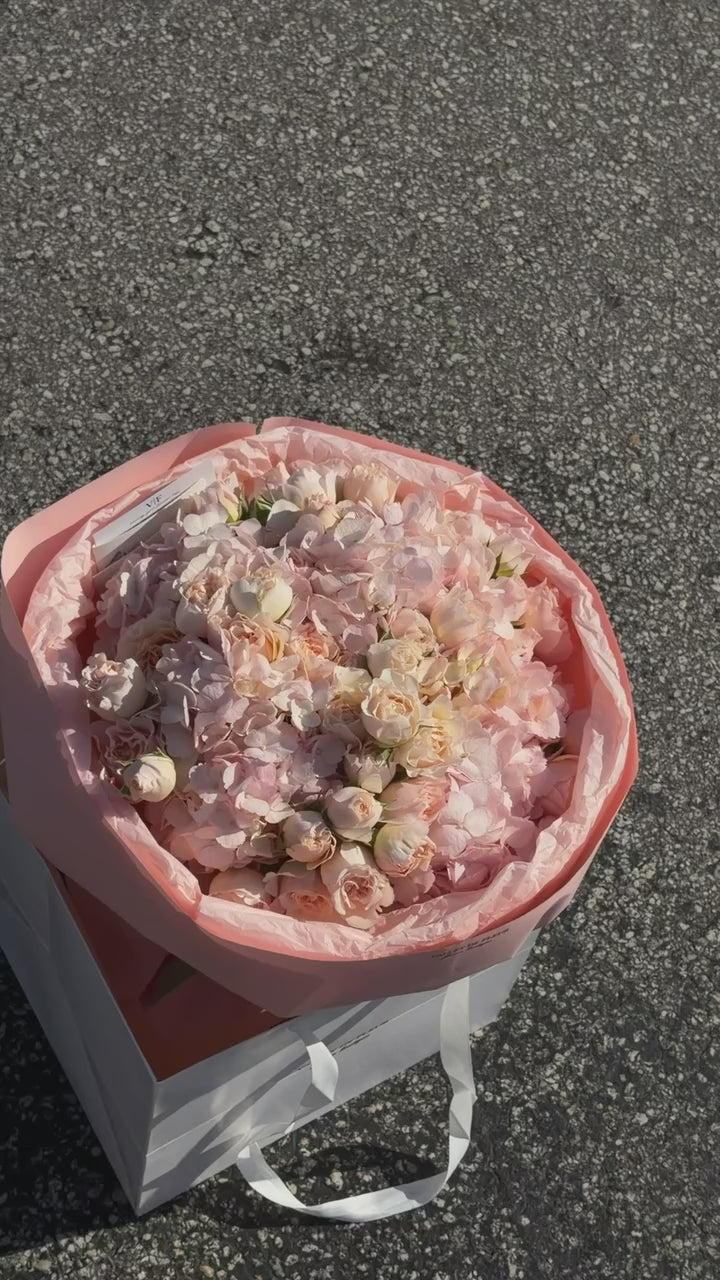 Spray roses and light pink hydrangeas in a blush birthday arrangement, ready for flower delivery across Miami-Dade and Broward County
