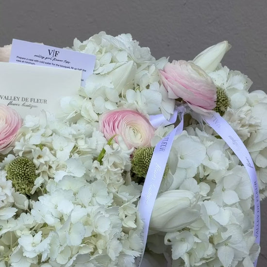 Hydrangeas, blush ranunculus and tulips birthday arrangement ready for flower delivery across Miami-Dade and Broward County