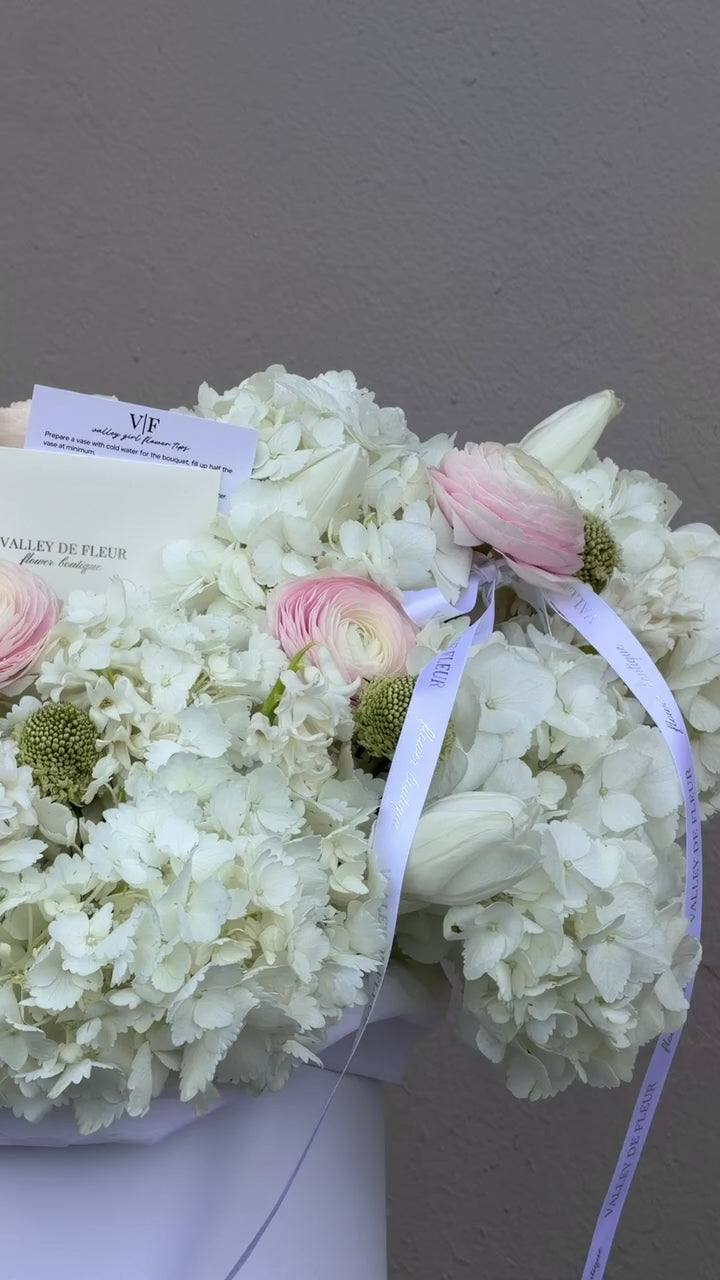Hydrangeas, blush ranunculus and tulips birthday arrangement ready for flower delivery across Miami-Dade and Broward County