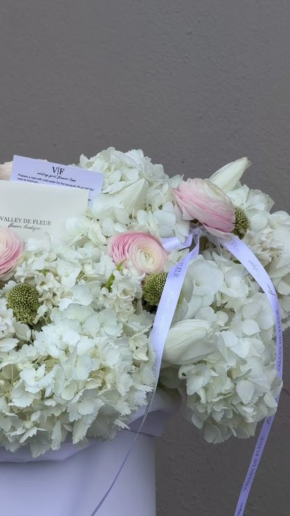 Hydrangeas, blush ranunculus and tulips birthday arrangement ready for flower delivery across Miami-Dade and Broward County