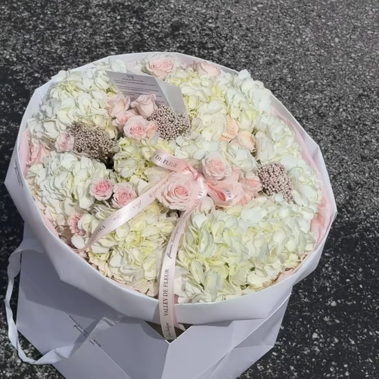 White hydrangeas and light pink Majolica roses birthday bouquet ready for flower delivery across Miami-Dade and Broward County