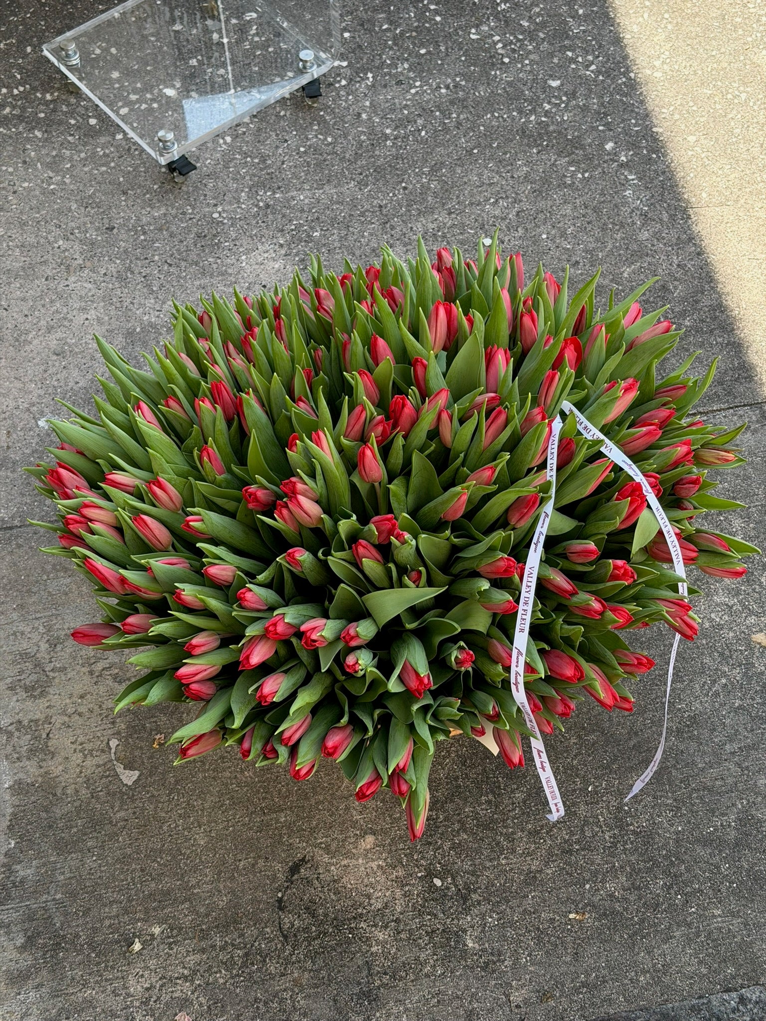 Large basket filled with red tulips for a birthday flower arrangement
