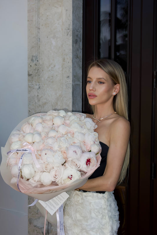 Blush Obsession rose bouquet featuring 50 roses and 50 peonies in a luxurious floral arrangement.